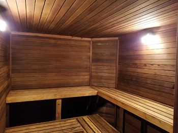 a sauna with wooden benches and a light